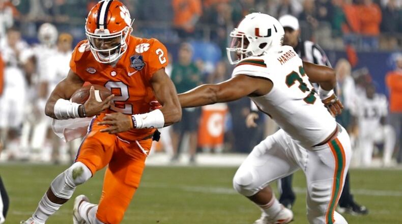 Clemson's Kelly Bryant (2) runs as Miami's Trent Harris (33) defends during the first half of the Atlantic Coast Conference championship NCAA college football game in Charlotte, N.C., Saturday, Dec. 2, 2017. (AP Photo/Bob Leverone)