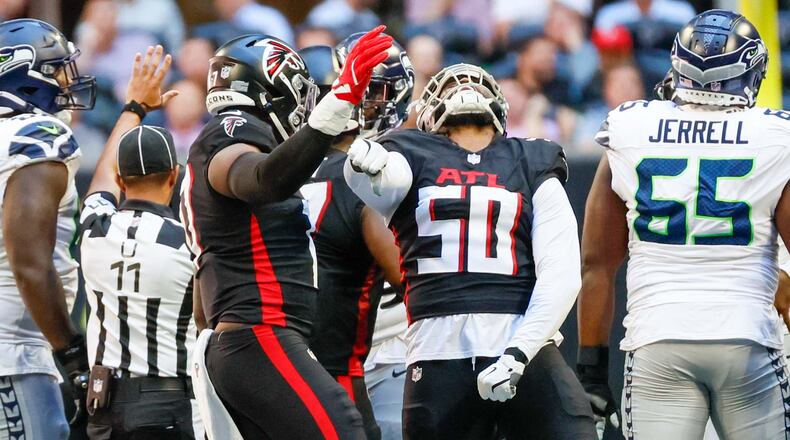 Falcons defensive end James Smith-Williams (50) reacts after sacking Seahawks quarterback Geno Smith (7) during the first half of an NFL football game on Sunday, October 20, 2024, at Mercedes-Benz Stadium in Atlanta. 
(Miguel Martinez/ AJC)