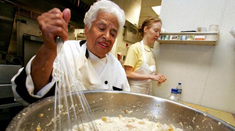 In this April 12, 2006, file photo, Leah Chase mixes her bread pudding at Muriel's restaurant in New Orleans.