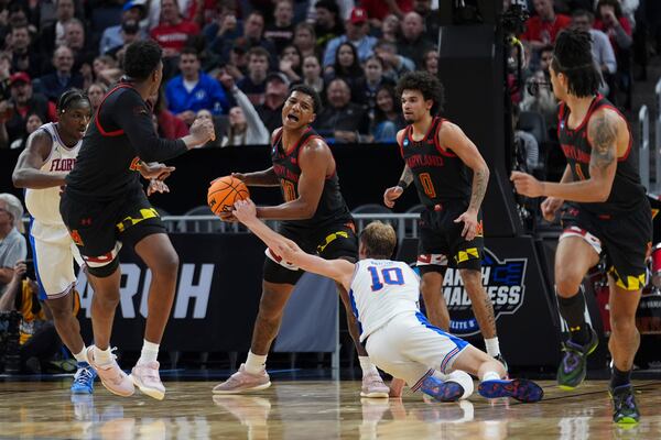 Maryland forward Julian Reese, center left, and Florida forward Thomas Haugh (10) reach for a rebound during the first half in the Sweet 16 of the NCAA college basketball tournament, Thursday, March 27, 2025, in San Francisco. (AP Photo/Marcio Jose Sanchez)
