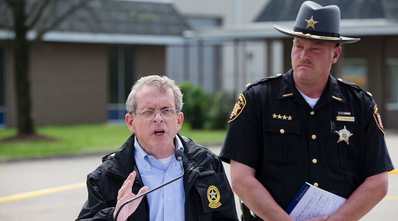 FILE - In this April 27, 2016, file photo, Ohio Attorney General Mike DeWine, left, and Pike County Sheriff Charles Reader, right, discuss the slayings of eight members of the Rhoden family found shot April 22, 2016, at four properties near Piketon, Ohio, during a news conference in Waverly, Ohio. The office of DeWine released redacted autopsy reports Friday, Sept. 23 in the unsolved slayings of the seven adults and a teenage boy, confirming all but one victim was shot multiple times in the head. (AP Photo/John Minchillo, File)