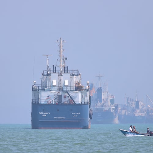 A small motorboat passes anchored vessels in the Strait of Hormuz off Bandar Abbas, Iran, Thursday, June 11, 2026.(Amirhosein Khorgooi/ISNA via AP)