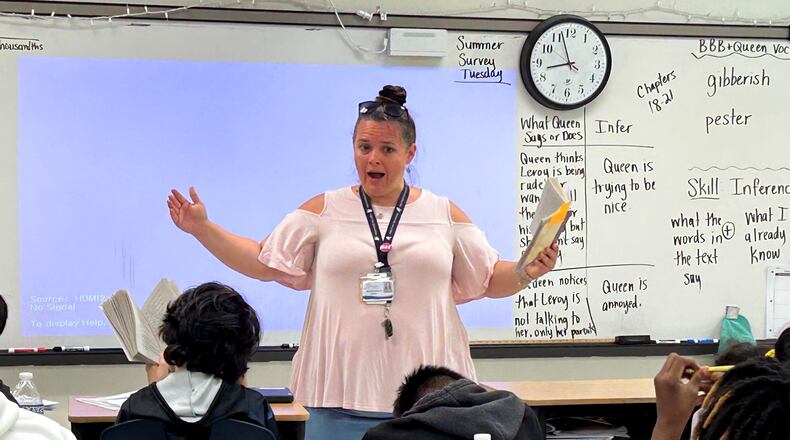 Fulton County teacher Jennifer Dallas works with a fifth grade class on making inferences using a book called "The Broken Bike Boy and the Queen of 33rd Street." Fulton is revamping its reading program to focus on the five pillars of literacy as defined by the National Reading Panel. (Martha Dalton/martha.dalton@ajc.com)