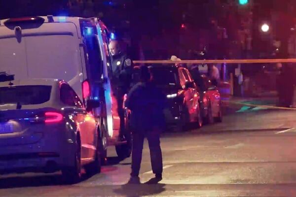 In this image taken from video provided by WJLA, a spectator watches as law enforcement works the scene after two staff members of the Israeli embassy in Washington were shot and killed outside the Capital Jewish Museum on Wednesday, May 21, 2025, in Washington. (WJLA via AP)