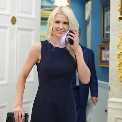 White House aide Natalie Harp is pictured using a cell phone as President Donald Trump speaks during an event about drug prices, in the Oval Office of the White House, Monday, Aug. 31, 2026, in Washington. (AP Photo/Jacquelyn Martin)