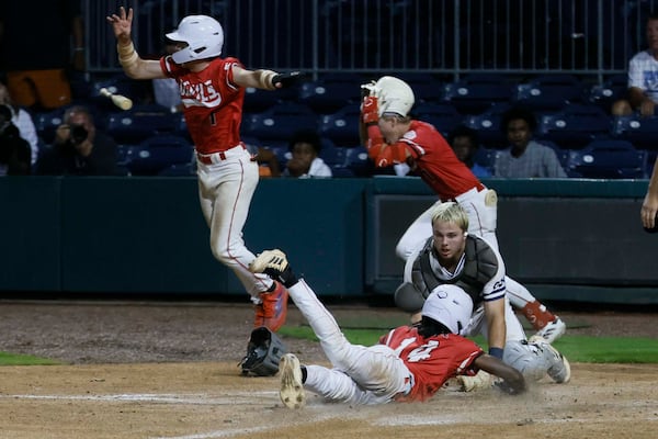 Loganville’s Teyton Braswell (bottom) safely scores at home to end the game during the seventh inning in Game 3 of the Class 5A baseball championship Series at Gwinnett Field on Tuesday, May 26, 2026, in Lawrenceville. Loganville won 4-3 with a walk-off hit by Aiden Gorvett.(Miguel Martinez/AJC)