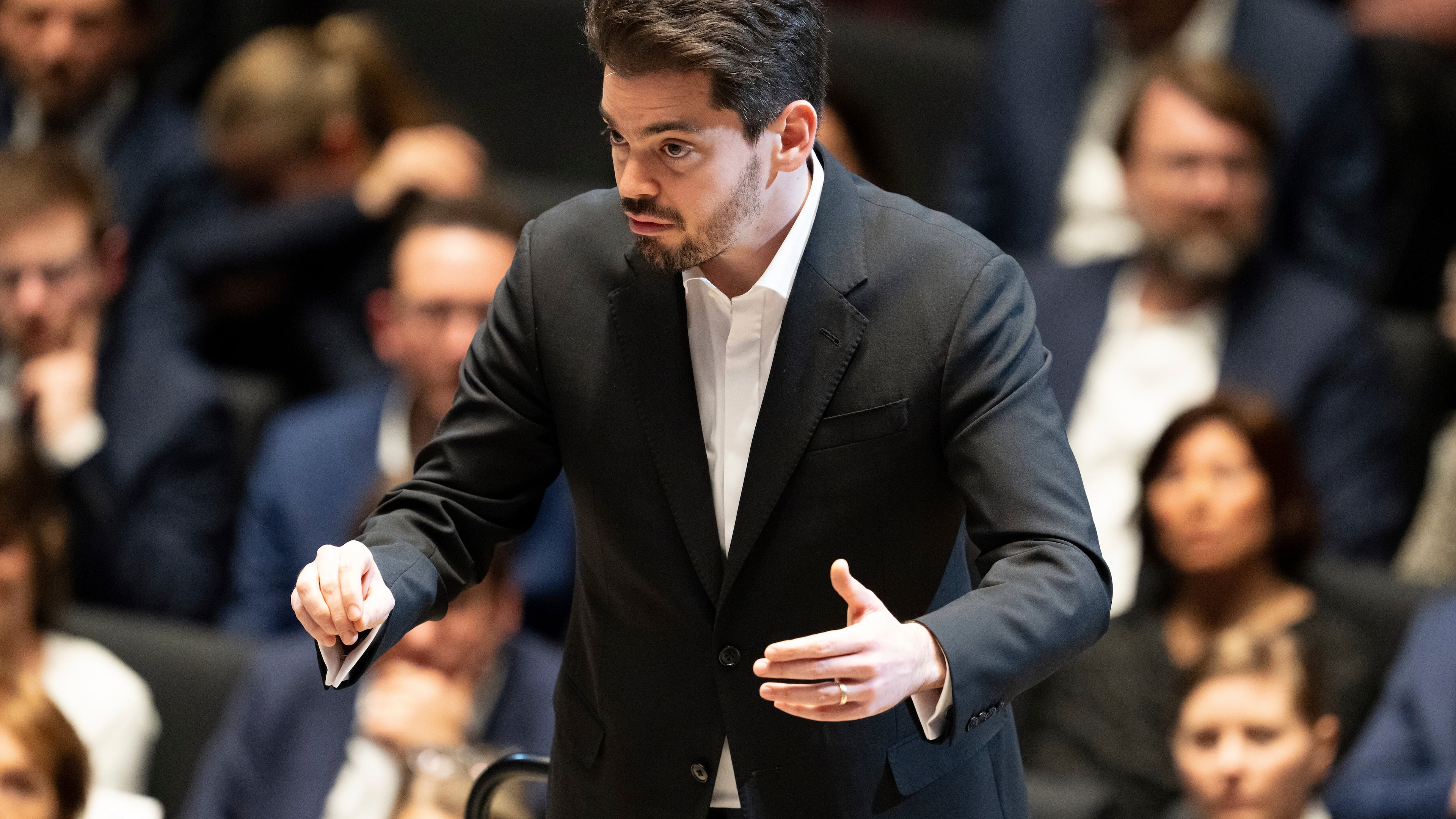 Israeli conductor Lahav Shani stands on stage after the awarding of the City of Munich's Golden Medal of Honor to conductor Zubin Mehta, in Munich, Germany, Jan. 26, 2024. (Sven Hoppe/dpa via AP)
