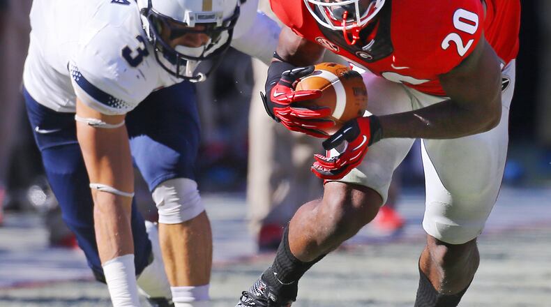 Georgia strong safety Quincey Mauger comes up with the turnover in front of Charleston Southern wide receiver Nathan Perera during the first half of a college football game on Saturday, Nov. 22, 2014, in Athens. CURTIS COMPTON / CCOMPTON@AJC.COM