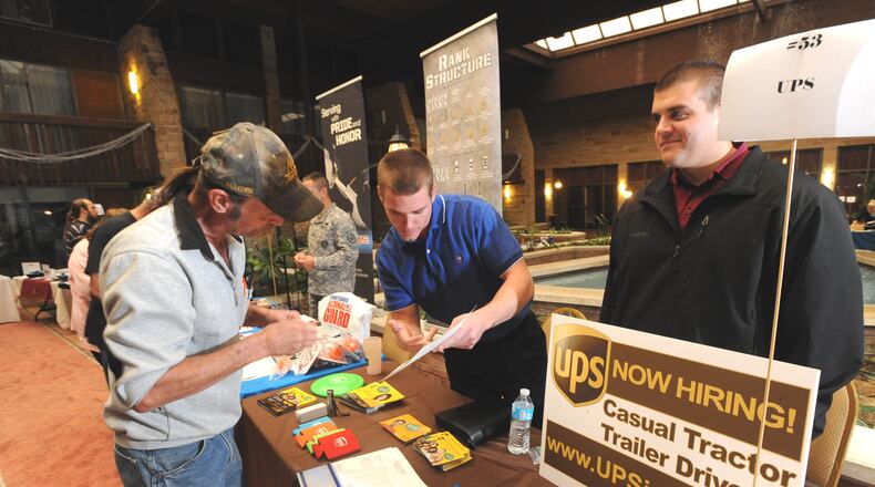 Ron Miller, left, of Somerset, Pa., talks to UPS representatives Patrick Heskey, center, and Aaron Zelmore, during the annual Somerset County Job Fair on Wednesday in Somerset, Pa.