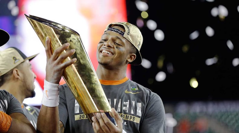 Gainesville, Ga. native DeShaun Watson holds the championship trophy after leading Clemson to a 35-31 victory over Alabama Monday in the college football playoff national championship game.