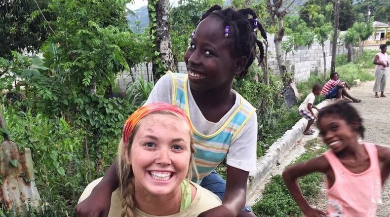 Cassidy Culberson, a Roswell special ed teacher, plays with some children on a recent mission trip to the Dominican Republic. CONTRIBUTED