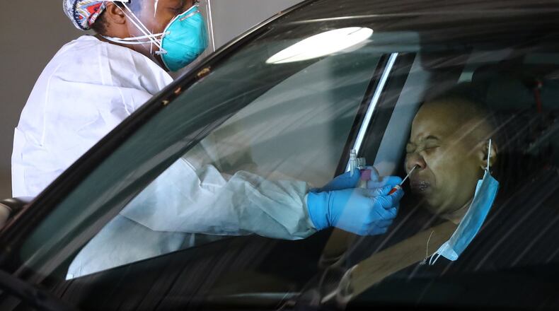 April 16, 2020 Conyers: GNR Health Department LPN LaToya Parterat takes a nasal swab at a large scale drive-through COVID-19 testing site at the Georgia International Horse Park recently on Thursday, April 16, 2020, in Conyers. Gov. Brian Kemp has made it a priority to expand testing in Georgia, which has lagged behind many other states in testing on a per capita basis. Public health experts say Georgia and other states need a substantial ramp up in testing to help isolate the virus and future outbreaks. Curtis Compton ccompton@ajc.com