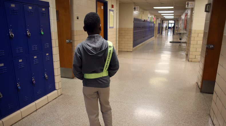 Adaryan McLendon, 11, mans his safety patrol post keeps an eye on a hallway at Chapel Hill Elementary School on Monday March 16, 2015 as classes are dismissed.