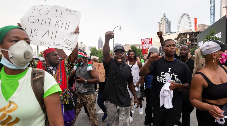 A man shouts as he ends a marches on Centennial Olympic Park Drive during protests Saturday in downtown Atlanta.