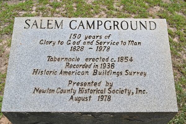 This picture shows a headstone outside the open-air tabernacle at Salem Camp Ground in Covington, site of one of the country’s oldest Christian revivals, on Wednesday, July 7, 2021. In 1998, the site was added to the National Register of Historic Places. (Hyosub Shin / Hyosub.Shin@ajc.com)
