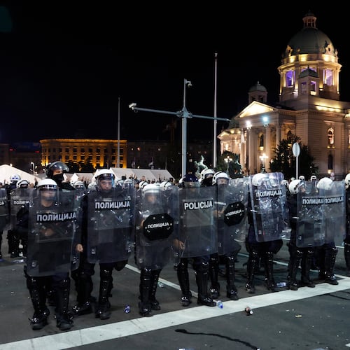 Serbian riot police separate rival crowds of opponents and loyalists of autocratic President Aleksandar Vucic, a day after tens of thousands of people joined a huge rally in the northern city of Novi Sad marking the first anniversary of a train station disaster there that killed 16 people, in Belgrade, Serbia, Sunday, Nov. 2, 2025. (AP Photo/Marko Drobnjakovic)