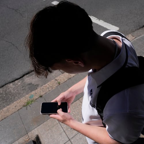 FILE - A teenage boy uses his phone in Sydney, Nov. 8, 2024. (AP Photo/Rick Rycroft, File)