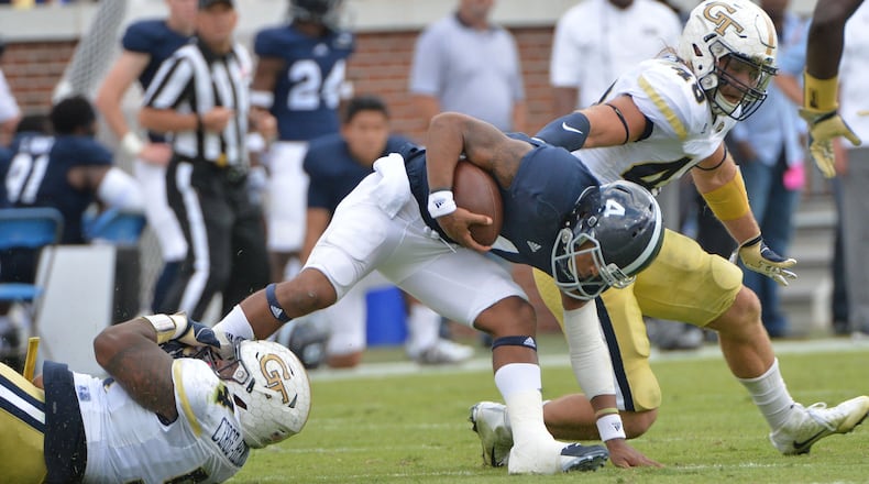 Georgia Southern quarterback Kevin Ellison (4) gets tackled by Georgia Tech defensive lineman Kyle Cerge-Henderson (left) in the second half at Bobby Dodd Stadium on Saturday, October 15, 2016. Georgia Tech won 35-24 over the Georgia Southern. HYOSUB SHIN / HSHIN@AJC.COM