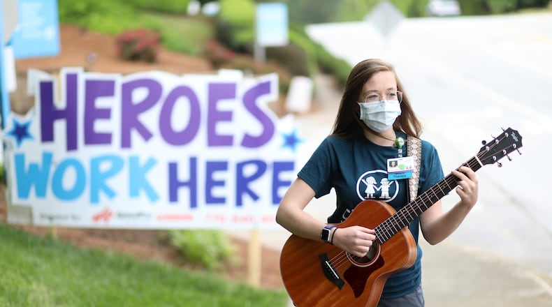 Music therapist Sarah McWaters poses outside the Children’s Healthcare in Atlanta. The coronavirus pandemic has altered how McWaters and other medical employees at the hospital do their job, despite the situation she has found the way to keep connected with her patients giving them music kits for them to ply at home. Friday, April 24, 2020. Miguel Martinez for the Atlanta Journal-Constitution