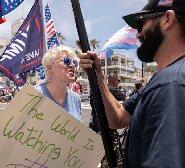 Michelle Kasper of Fountain Valley, argues with a Trump supporter who said his name is Donald J. Trump during the No Kings protest in Huntington Beach, Calif., on Saturday, June 14, 2025. (Mindy Schauer/The Orange County Register via AP)