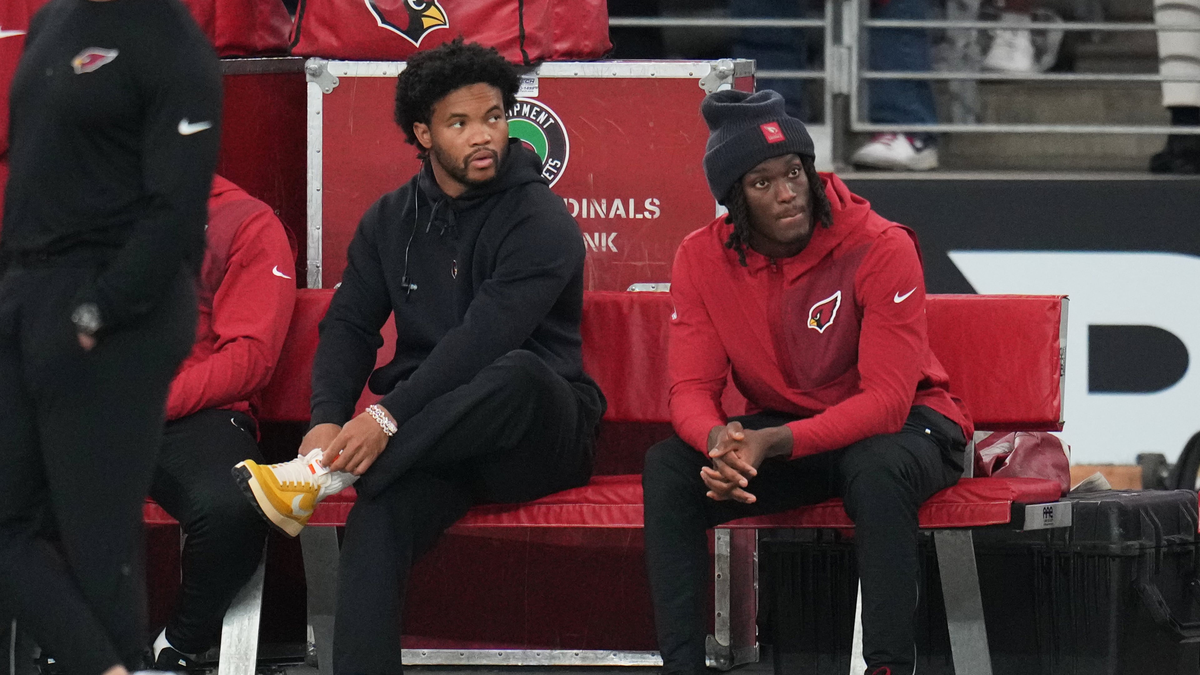 Arizona Cardinals quarterback Kyler Murray, left, and wide receiver Marvin Harrison Jr. sit on the bench during the first half of an NFL football game against the Jacksonville Jaguars Sunday, Nov. 23, 2025, in Glendale, Ariz. (AP Photo/Rick Scuteri)