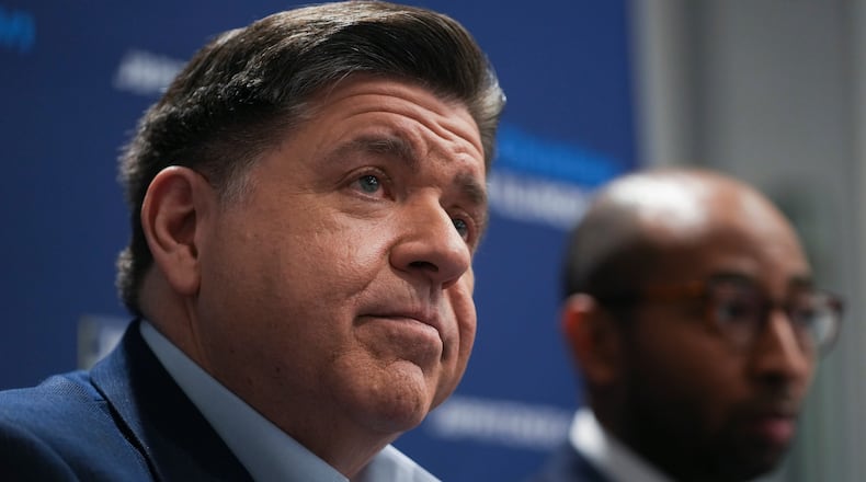 Illinois Gov. JB Pritzker, left, and running mate, candidate for lieutenant governor, Christian Mitchell speak during an interview, Wednesday, March 18, 2026, in Chicago. (AP Photo/Erin Hooley)