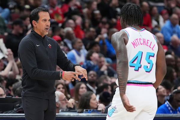 Miami Heat head coach Erik Spoelstra, left, talks to guard Davion Mitchell during the second half of an NBA basketball game against the Chicago Bulls in Chicago, Wednesday, April 9, 2025. (AP Photo/Nam Y. Huh)