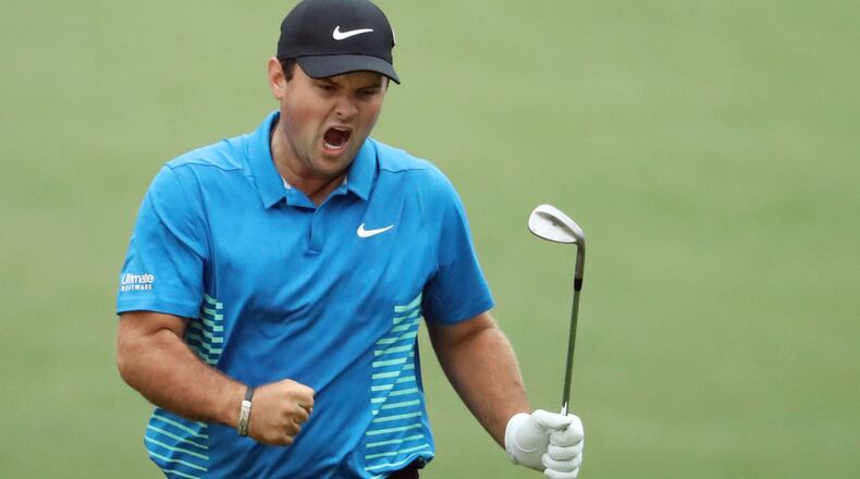 Patrick Reed celebrates his eagle chip on the 15th hole during the third round of the Masters Saturday at Augusta National Golf Club.
