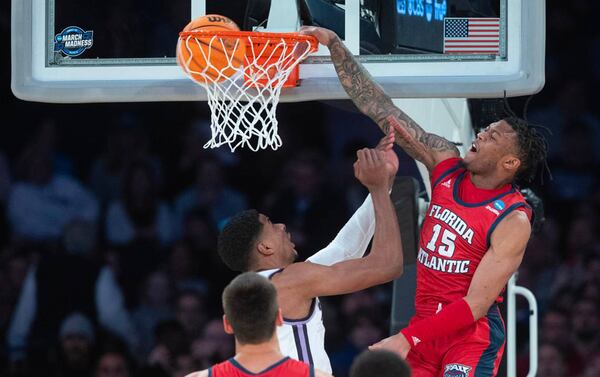 Florida Atlantic's Alijah Martin dunks the ball over Kansas State's David N'Guessan during the first half of their east region final game during the NCAA Men's Basketball Tournament at Madison Square Garden on Saturday night, March 25, 2023. (Travis Heying/The Wichita Eagle/TNS)