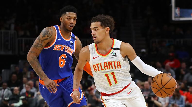 Hawks guard Trae Young drives against New York Knicks guard Elfrid Payton in a NBA basketball game on Wednesday, March 11, 2020, in Atlanta. As the country grapples with coronavirus and how to best combat the spread of the disease, athletic teams and organizations are asking themselves that same question. Curtis Compton ccompton@ajc.com