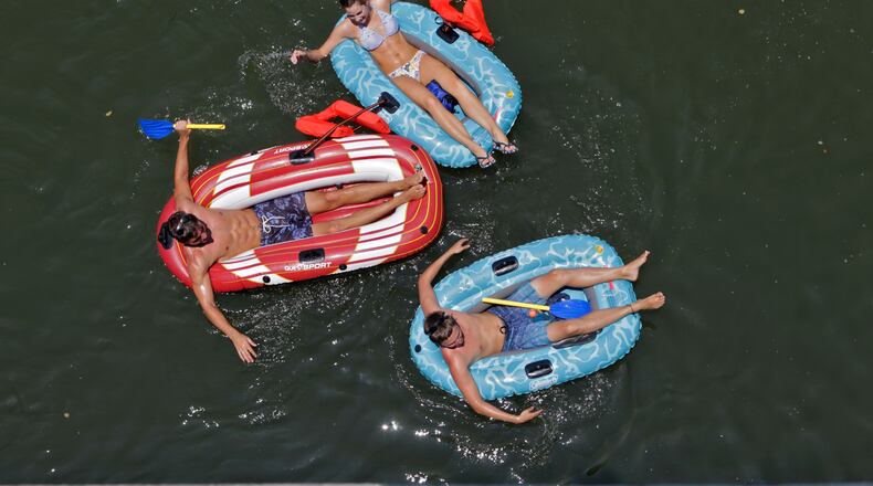 Eric Prokopovich (left), Oana Dimulescu and Sam Larsen shoot the 'hooch in Cobb County. Bob Andres/bandres@ajc.com