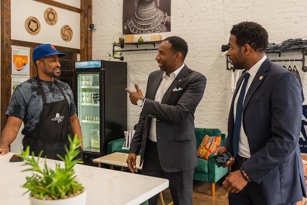 Fulton County Commissioner Candidate Ali Carter and Atlanta Mayor Andre Dickens meet supporters during local campaigning on Thursday, May 9, 2024, in the Cascade Heights neighborhood of Atlanta. (Atlanta Journal-Constitution/Jason Allen)