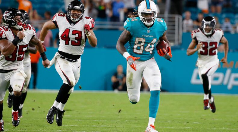Miami Dolphins wide receiver Damore'ea Stringfellow (84) runs for a touchdown ahead of Atlanta Falcons linebacker Jack Lynn (43), cornerback Jalen Collins (32) and defensive back Marcelis Branch (35), during the second half of an NFL preseason football game, Thursday, Aug. 10, 2017, in Miami Gardens, Fla. (AP Photo/Wilfredo Lee)
