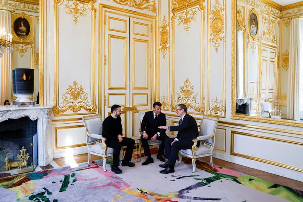 Ukraine's President Volodymyr Zelenskyy, left, French President Emmanuel Macron, center, and Britain's Prime Minister Keir Starmer speak during a trilateral meeting on the sidelines of a summit for "coalition of the willing" at the Elysee Palace, Thursday, March 27, 2025. (Ludovic Marin, Pool via AP)