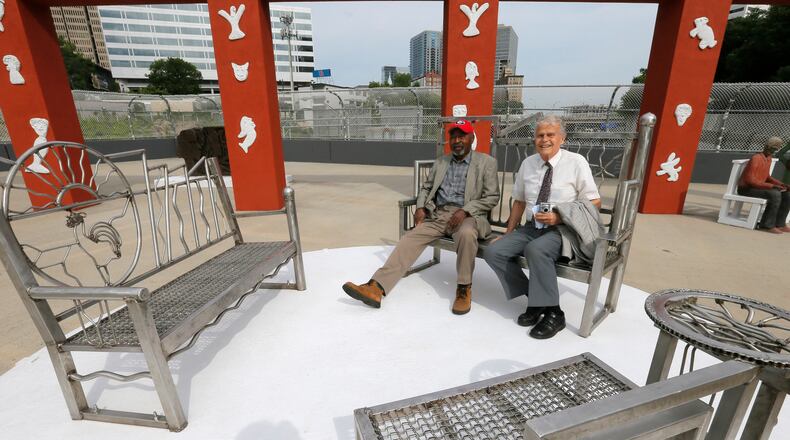 Artist Harold Rittenberry and original architect Bob Clements sit among the welded stainless steel benches created by Rittenberry. Folk Art Park, GDOT's first public art project and created in 1996 as part of the city's Olympics projects, reopened June 1.