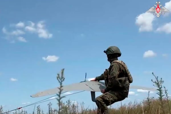 In this photo taken from video distributed by Russian Defense Ministry Press Service on Thursday, July 17, 2025, a Russian serviceman operates a "Supercam" drone in an undisclosed location in Ukraine. (Russian Defense Ministry Press Service via AP)