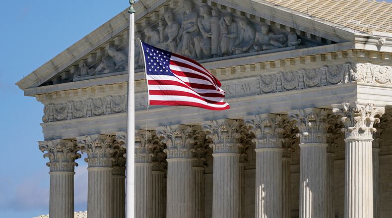FILE - An American flag waves in front of the Supreme Court building on Capitol Hill in Washington, on Nov. 2, 2020. (AP Photo/Patrick Semansky, File)