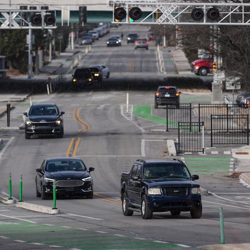 Cars make their way onto the recently converted two-way portion of Michigan Street in Indianapolis, Thursday, Jan. 15, 2026. (AP Photo/Michael Conroy)
