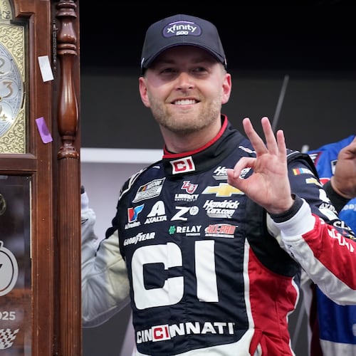 William Byron poses with the trophy in Victory Lane after winning a NASCAR Cup series auto race in Martinsville, Va., Sunday, Oct. 26, 2025. (AP Photo/Chuck Burton)