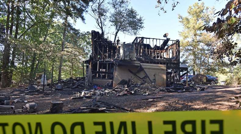 Five adults were found dead after a fire gutted a home in the 2200 block of Post Oak Drive in unincorporated Duluth early Sunday morning. HYOSUB SHIN / HSHIN@AJC.COM