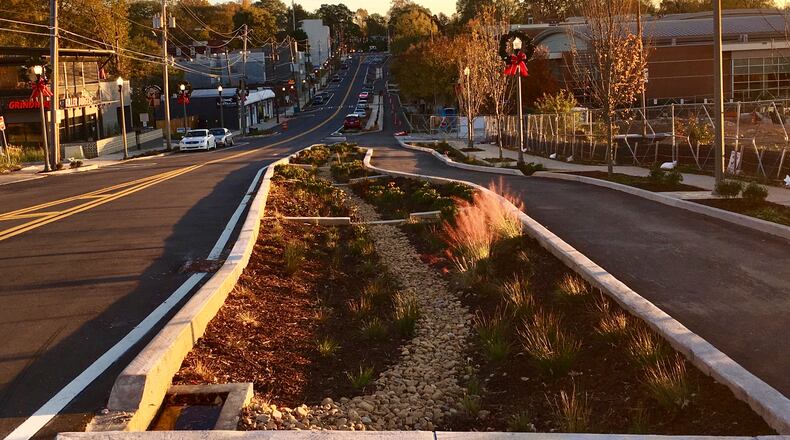 Avondale Estates’ redesign of U.S. 278 may ultimatley look similar to this, North McDonough Road in Decatur from Trinity Place to Howard Avenue, which recently finished. Avondale’s interested in a lane reduction from five to three lanes (here it was four to two), green infrastructure in the middle, a two-way bike lane to the right and wide sidewalks on either side. Bill Banks for the AJC