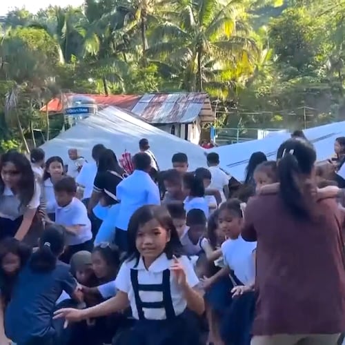 This image made from video provided by DepEd Mahayahay Elementary School shows school children reacting as a canopy roof, rear, collapsed, caused by a powerful earthquake Monday, June 8, 2026, in Malita, Davao Occidental Province, Philippines. (DepEd Mahayahay Elementary School via AP)