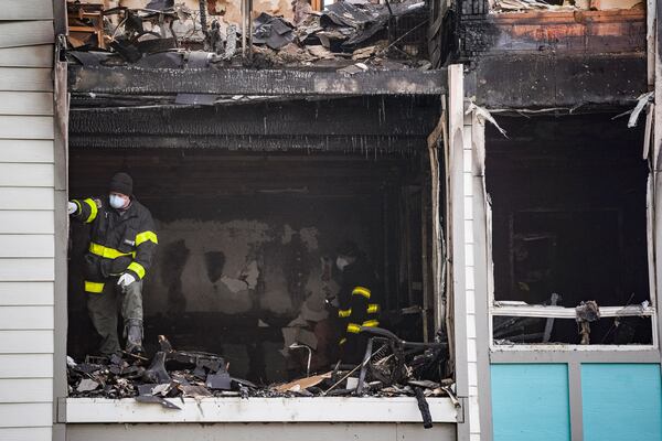 A Cobb County fire investigator stands inside a burned apartment in the Concord Crossing complex Monday, Feb 23, 2026, following an overnight fire that killed three. (Ben Hendren for the AJC)