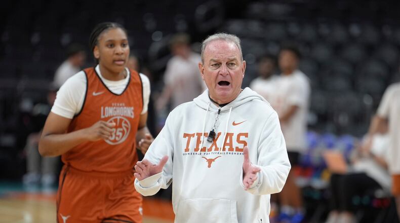 Texas head coach Vic Schaefer, right, encourages his players at Texas forward Madison Booker (35) runs the court during practice prior to the national semifinals Women's Final Four of the NCAA college basketball tournament, Thursday, April 2, 2026, in Phoenix. (AP Photo/Ross D. Franklin)