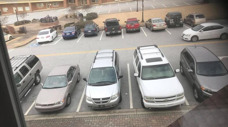 Powder Springs business owners, whose businesses front one side of Marietta Street, are expressing their concerns about the city’s proposed parking plan for the expanded Historic Square. They all would lose one strip of parking spaces behind their businesses. This view is taken from inside Hand Me Ups, a consignment store going into its 30th year of business. Courtesy of Hand Me Ups