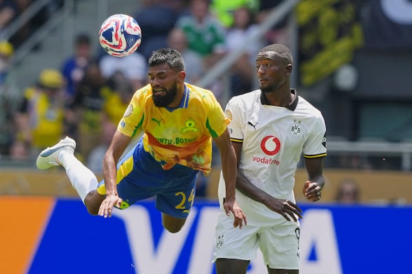 Mamelodi Sundowns' Keanu Cupido, left, and Borussia Dortmund's Serhou Guirassy (9) battle for the ball during the Club World Cup Group F soccer match between Mamelodi Sundowns and Borussia Dortmund in Cincinnati, Saturday, June 21, 2025. (AP Photo/Carolyn Kaster)