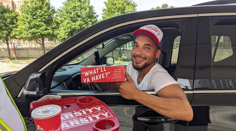 Atlanta resident Jake Major is the first customer at the Varsity's new drive-thru. The iconic Midtown restaurant suspended carhop service earlier this year due to the pandemic.  / Varsity Facebook page