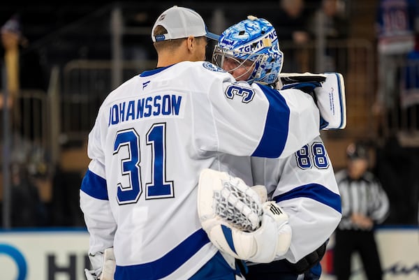 Tampa Bay Lightning goaltender Jonas Johansson (31) congratulates goaltender Andrei Vasilevskiy (88) after an NHL hockey game against the New York Rangers, Monday, April 7, 2025, in New York. (AP Photo/Angelina Katsanis)