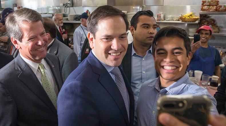 A supporter takes a selfie with Florida U.S. Sen. Marco Rubio, center, and Republican gubernatorial candidate Brian Kemp, left. (ALYSSA POINTER/ALYSSA.POINTER@AJC.COM)