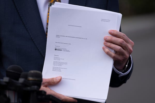 FILEL - Energy Secretary Chris Wright holds a report concerning U.S. exports of liquefied natural gas (LNG) as he speaks to reporters at the White House in Washington, on March 19, 2025. (AP Photo/Ben Curtis, File)
